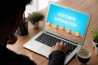 An image showing a random person using a laptop to optimize Optimize Customer Buying Journey for Higher Conversions
